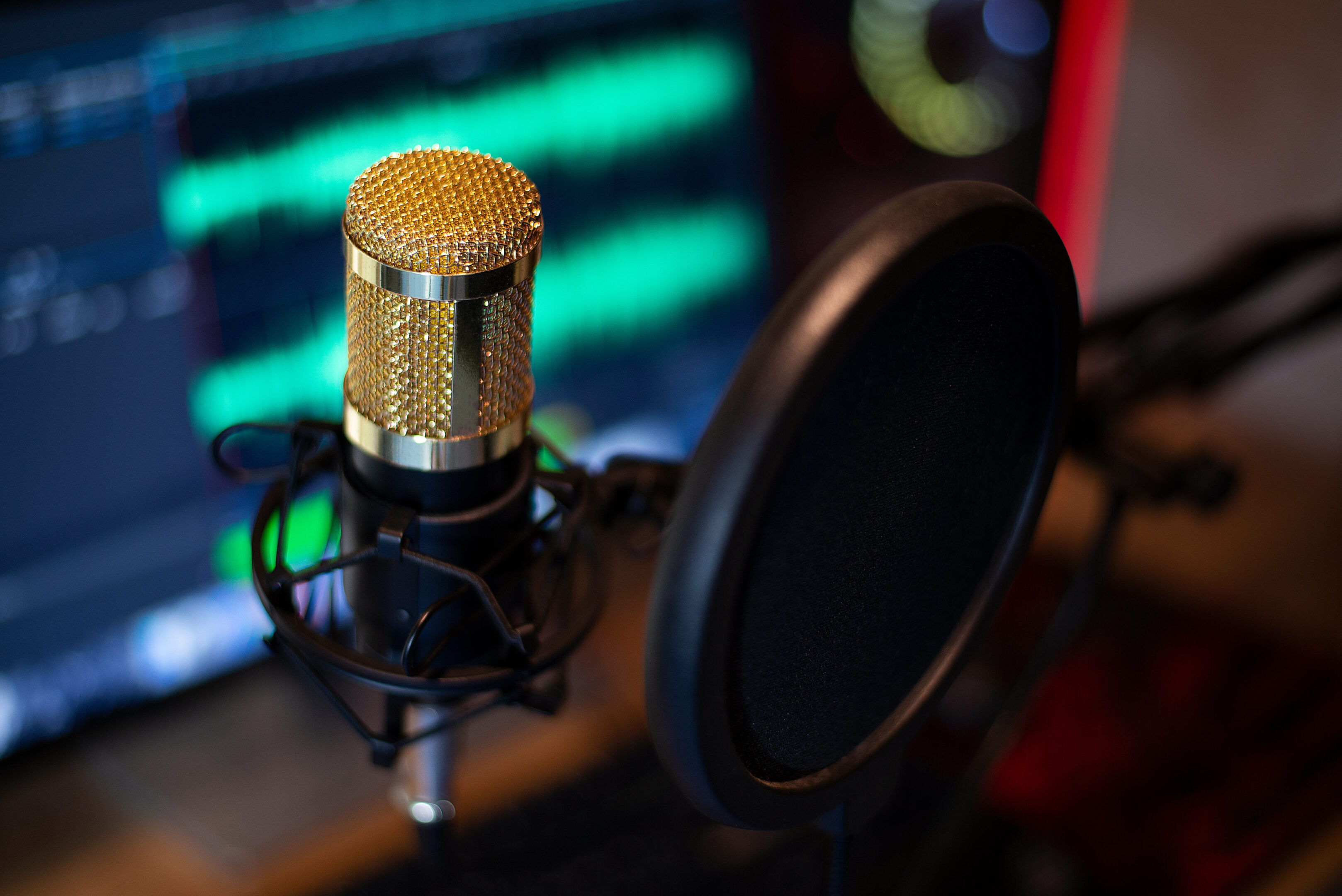 A professional microphone with a pop filter in a recording studio.